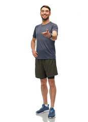 Fototapeta premium fitness, sport and healthy lifestyle concept - smiling man in sports clothes with smart watch or tracker pointing finger to camera over white background