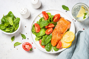 Salmon fillet with fresh salad. Baked salmon at white table. healthy food, keto diet. Healthy lunch...
