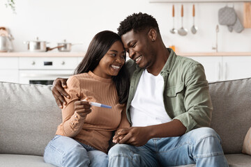 African american couple with positive results of pregnancy test