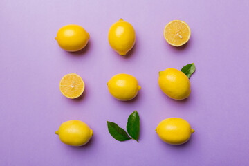 Many fresh ripe lemons as colored background, top view. Elegant background of lemon and lemon slices Top view flat lay