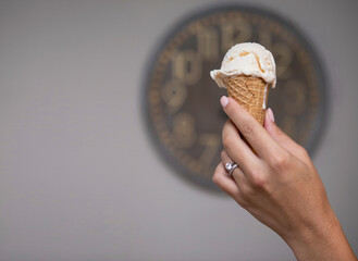 Hand Holding Vanilla Ice Cream in Cone