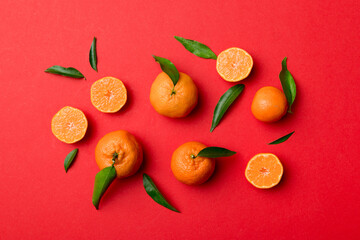 Many fresh ripe mandarin as colored background, top view. Elegant background of clementines and mandarin slices Top view flat lay