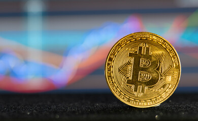 Close up bitcoin and digital stock market graph bar on black. Cryptocurrency. Bitcoin Stock Growth....