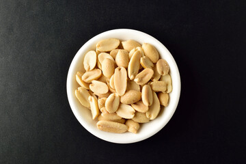 Top View of Salted Peanuts in Bowl on Dark Background
