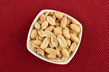 Top View of Salted Peanuts Bowl on Red Placemat, healthy Snacks