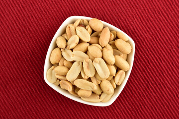 Bowl of Salted Peanuts on red Kitchen cloth
