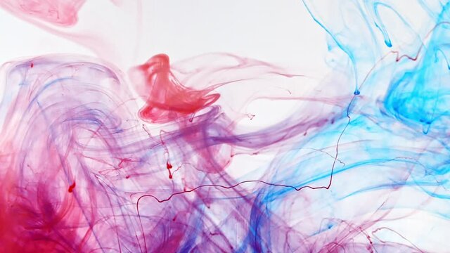 Color ink in water on white background. Paint drops mixing in water, Ink swirling underwater. Colored cloud abstract smoke explosion. Abstract color mix. Macro shot. High quality FullHD footage