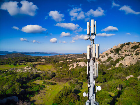 Cell phone communication antenna tower with rural countryside landscape - Powered by Adobe
