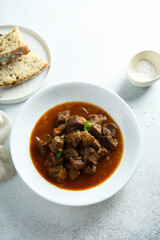 Traditional homemade beef goulash served with bread