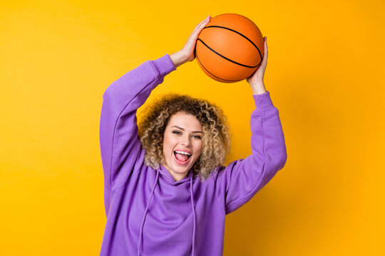 Photo of young cheerful girl good mood play game sportive hobby weekend isolated over yellow color background