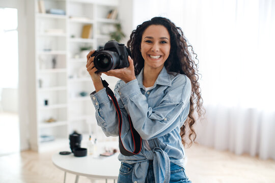 Happy Female Photographer Holding Photo Camera Taking Pictures Standing Indoors