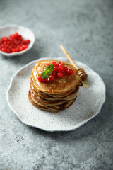 Homemade pancakes with berries and honey