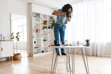 Fototapeta premium Photographer Woman Taking Photo Of Cosmetics Products On Desktop Indoor