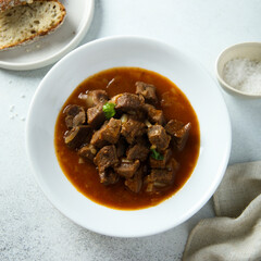 Traditional homemade beef goulash served with bread
