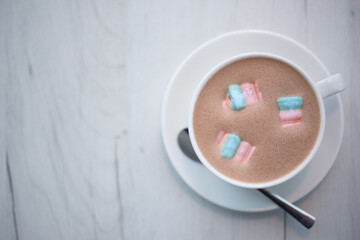  A cup of cocoa with marshmallows in a cafe on a wooden table