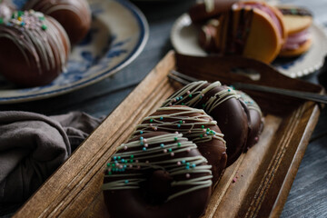 Various homemade desserts on vintage dishes. Rustic style. Dark blue wooden table