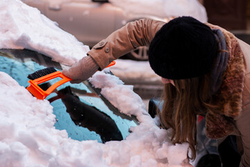 Cleaning snow from windshield. Winter car front windows clean.