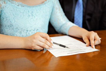 hands of brides signing a marriage declaration. wedding.