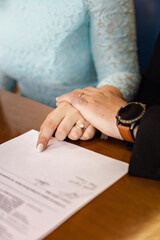 hands of brides signing a marriage declaration. wedding.