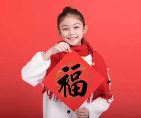 Happy chinese new year. Girl showing Spring Festival couplets. chinese text lucky