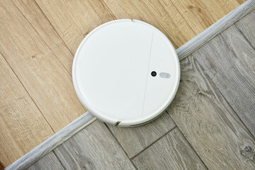 Robot vacuum cleaner drives on different surface. Overcoming doorstep with robot vacuum cleaner....