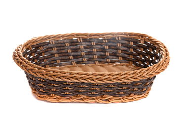 Obraz premium brown wicker fruit basket on white isolated background