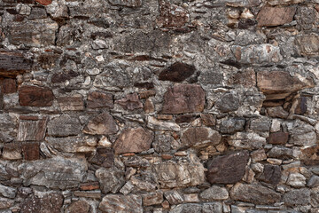 Old grungy retro dirty faded brick wall of ancient city. Uneven pitted peeled surface brickwork of cellar worn. Ruined shabby stiff blocks.Hard solid messy ragged holes brickwall of 3D grunge design