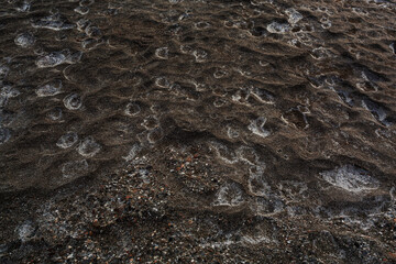 Street covered pebbles on sea coast.Rough uneven little bit fraction grunge marble terrace pathway.Damaged breaking old rustic stone. Scratched shabby grungy granite lava for 3d seaside vintage design