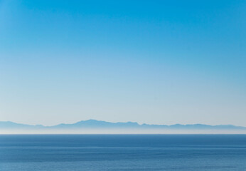 Obraz premium a landscape background wallpaper image looking out over the Mediterranean Sea at the mountainous coast of northern Africa 