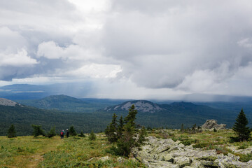 View on a rain clouds over mountain forest valley