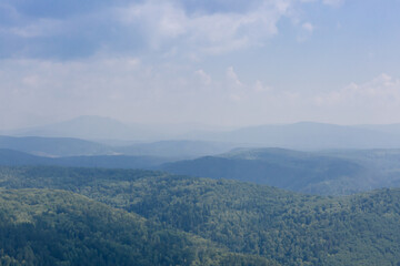 Fototapeta premium Foggy mountain forest hills in nature reservein Russia