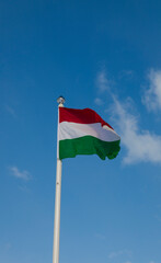 Hungary flag isolated on sky background with clipping path. Close-up waving flag of Hungary. 