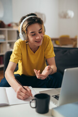 teenager boy having online class from home