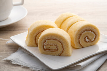 Close up Vanilla Swiss roll Cake on white plate