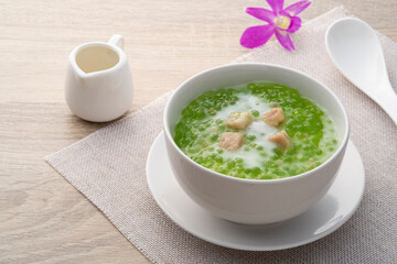 Pandan flavoured Tapioca pearl pudding with a dash of coconut milk,popular South-East Asian dessert in white bowl