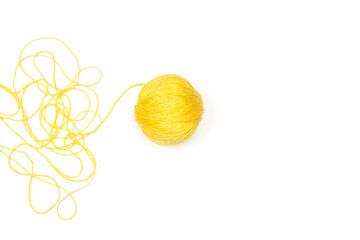 Una bola de lana amarilla sobre un fondo blanco liso y aislado. Vista superior y de cerca. Copy space