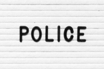 Black alphabet letter in word police on white felt board background