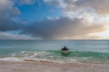 Fisherman with rowing boat off Burgau in the Algarve