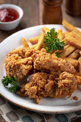 Crispy fried chicken tenders and french fries