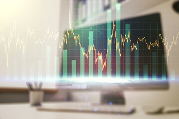 Abstract creative financial graph and modern desktop with computer on background, forex and investment concept. Multiexposure
