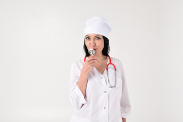 A female therapist with a stethoscope in the clinic on a white background
