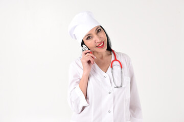 A female therapist with a stethoscope as if with a phone in the clinic on a white background