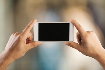 Hands hold smartphone with blank screen