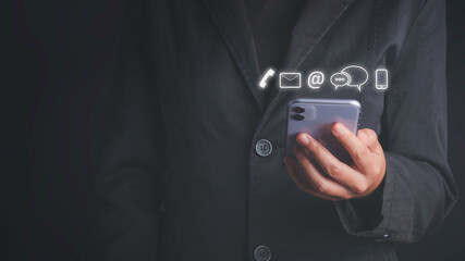 Contact us and Customer support hotline concept. icon email, address, phone. Businessman holding Smart Phone connection to customer service and support for self.