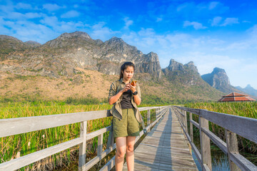 Fototapeta na wymiar Hiking. Asian female hikers carry heavy backpacking on hiking trails. Live a healthy life