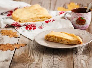 Cabbage pie on wooden background country style.