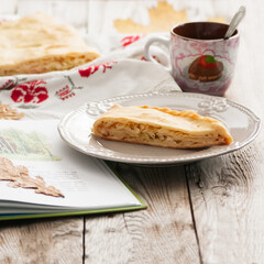 Cabbage pie on wooden background country style.