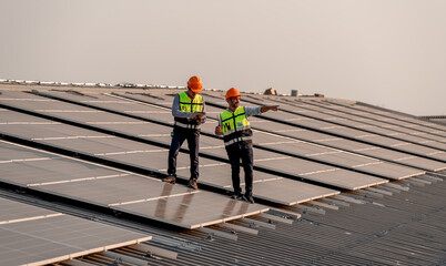 Engineer wearing unifrom and helmet inspect and check solar cell panel ,solar cell is ecology...