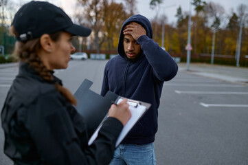 Upset man and police woman issuing fine