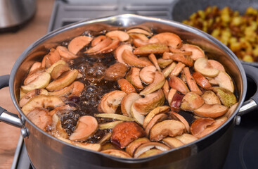 Compote of dried fruit apples is cooked in a pan with water, close up